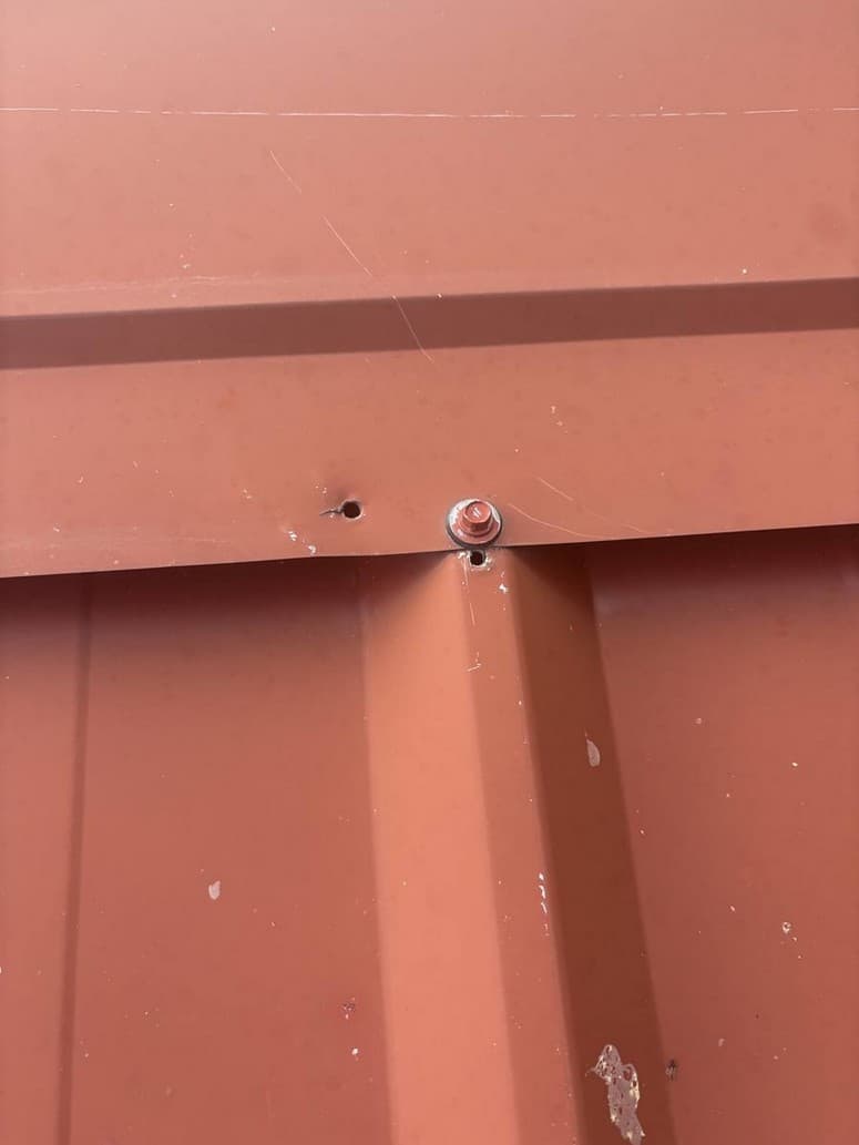 Photo 7 — Empty hole next to a screw, and another hole at the rib.