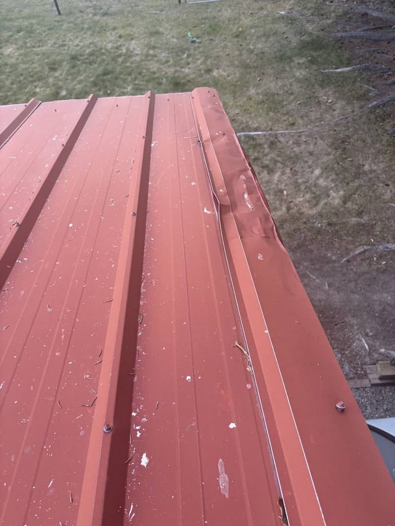 Photo 10 — Gap down the rake. Water can get behind the metal onto the fascia.